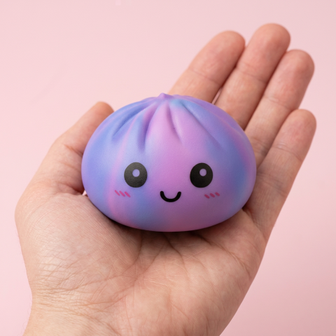 Squishy Dumpling Tie Dye Lila mit Mini-Dampfkorb in der Hand gehalten, echte Größe